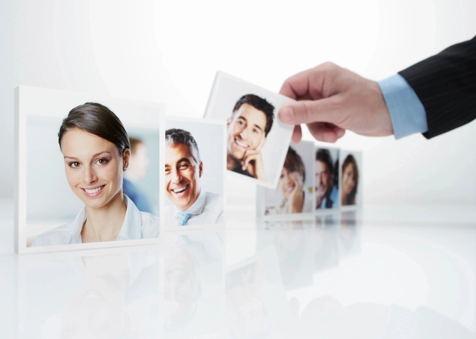 Recruitment professional reviewing candidate portraits